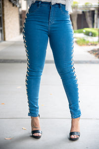 Skinny Jean with lace up detail featuring an open side hand punching eyelet.  EXCELLENT STRETCH DENIM.
